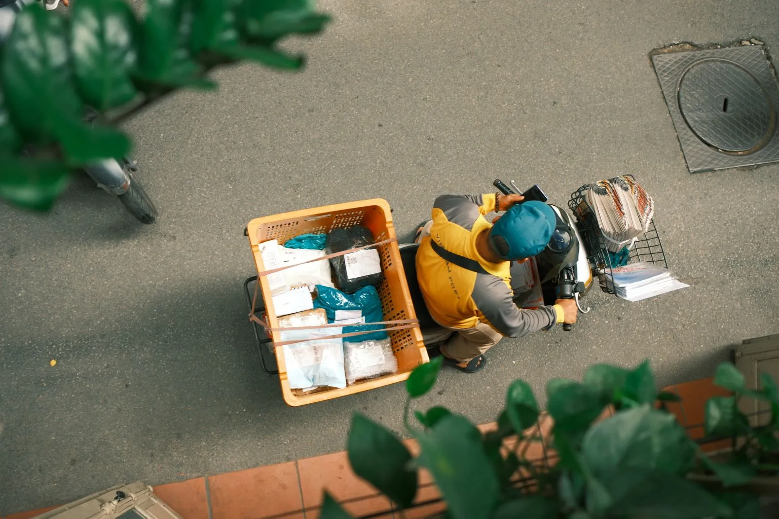Overhead view of a courier's scooter loaded with delivery crates.