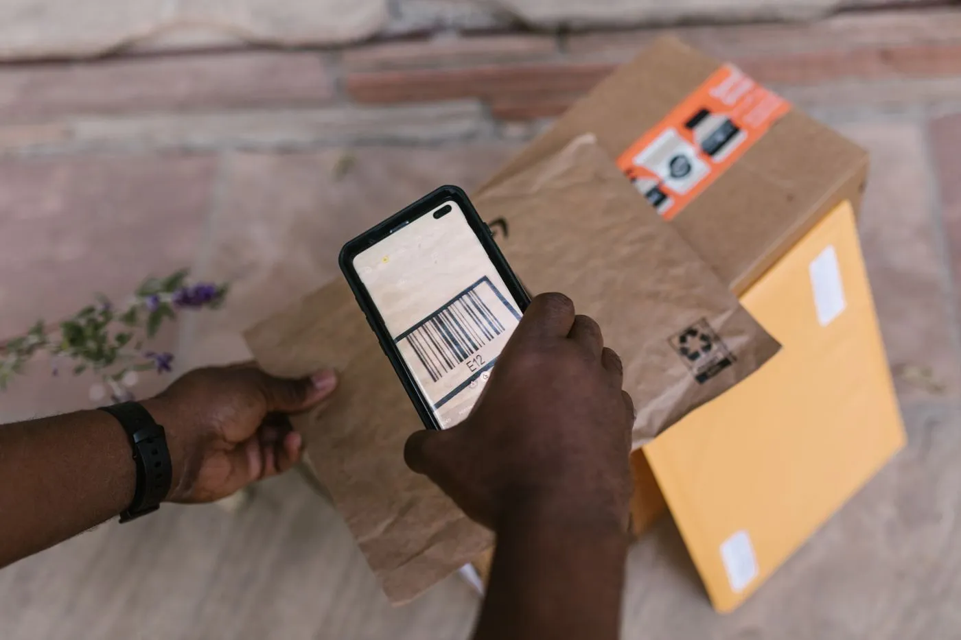 A parcel barcode being scanned with a phone at handover.